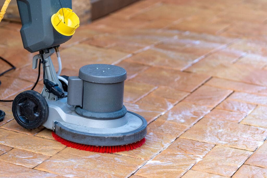 Tile Cleaning Pros use a scrubbing machine to clean tile and grout.